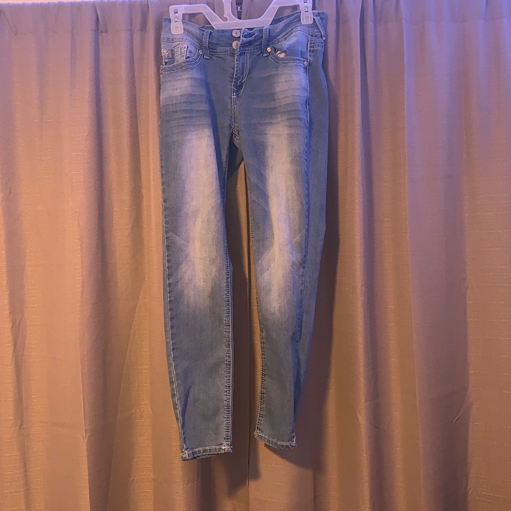Mid rise blue skinny jeans.